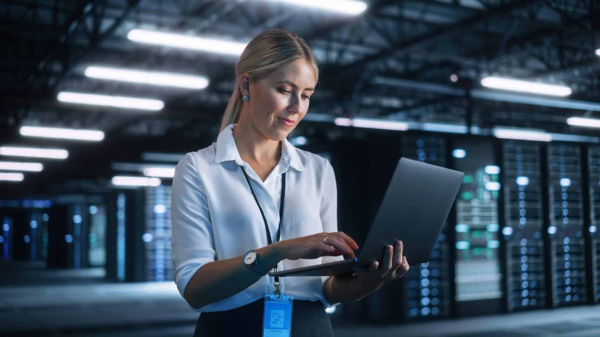 Female,Engineer,Holding,Laptop,Computer,At,Hands,While,Programs,Something.