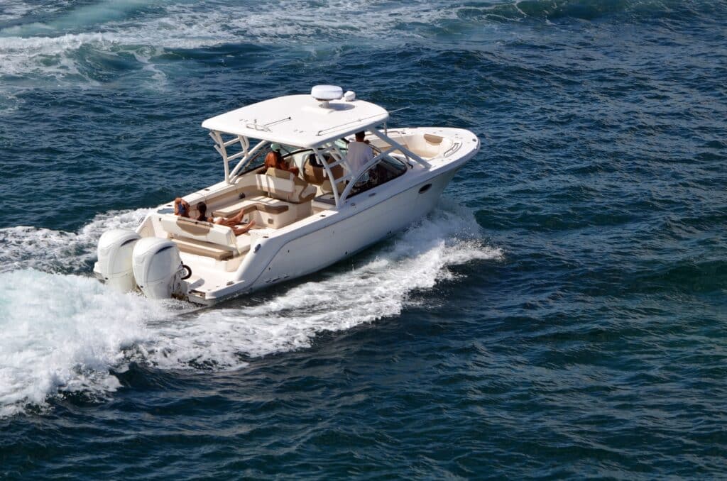 White,Fishing,Boat,Powered,By,Two,Outboard,Engines,Cruising,On